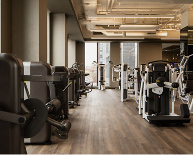 Strength training equipment on the fitness floor at the Life Time Atlantic Avenue club location