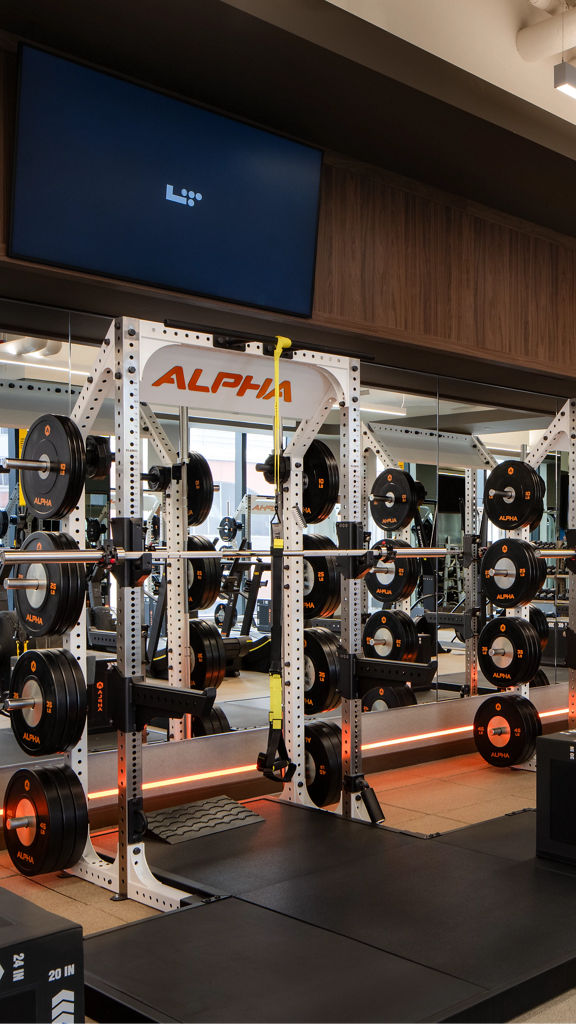 Strength training equipment on the fitness floor at the Life Time Atlantic Avenue club location