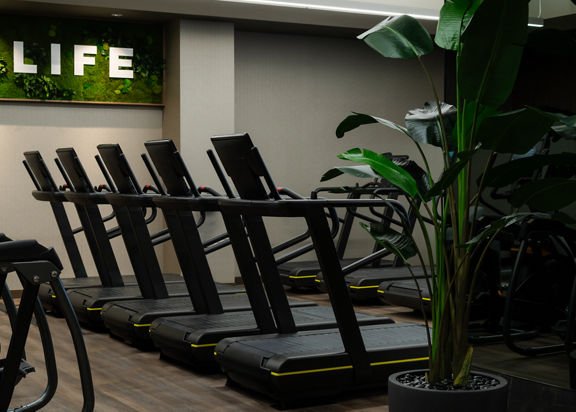 Row of treadmills on the fitness floor at the Life Time Atlantic Avenue club location