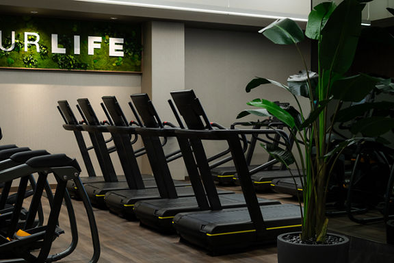 Row of treadmills on the fitness floor at the Life Time Atlantic Avenue club location