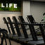 Row of treadmills on the fitness floor at the Life Time Atlantic Avenue club location