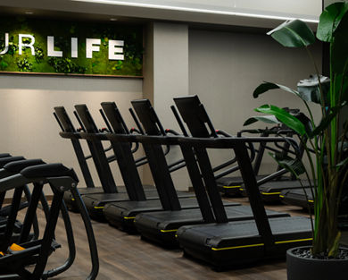 Row of treadmills on the fitness floor at the Life Time Atlantic Avenue club location