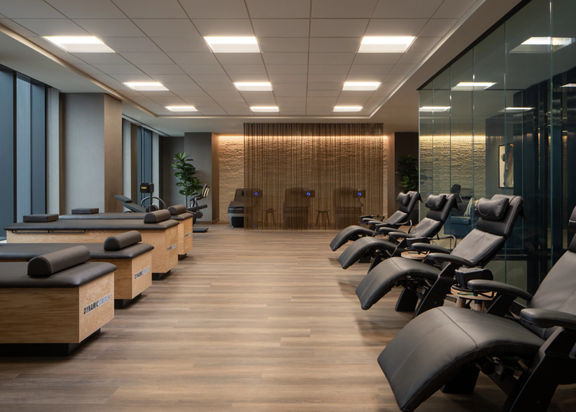 Dynamic Stretch tables and chairs lined up in the recovery area at Life Time