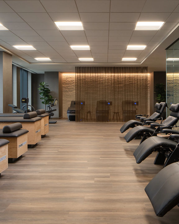 Dynamic Stretch tables and chairs lined up in the recovery area at Life Time