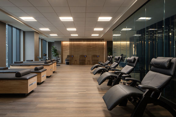 Dynamic Stretch tables and chairs lined up in the recovery area at Life Time