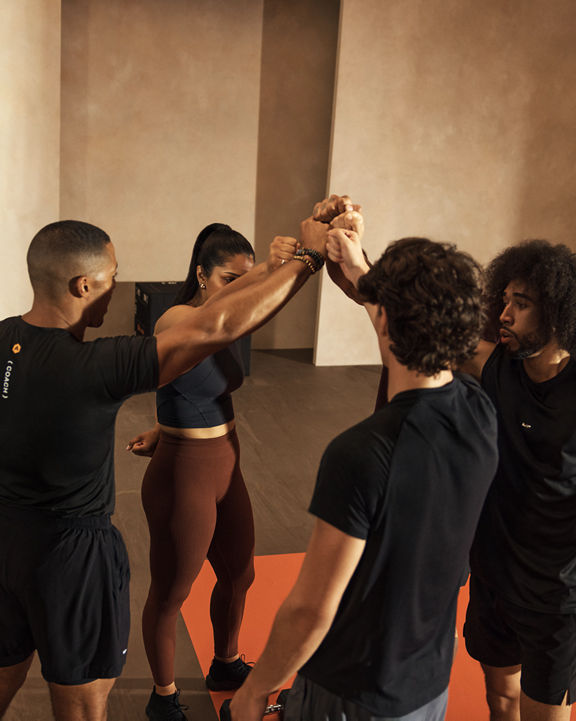 Alpha class participants high five after working out