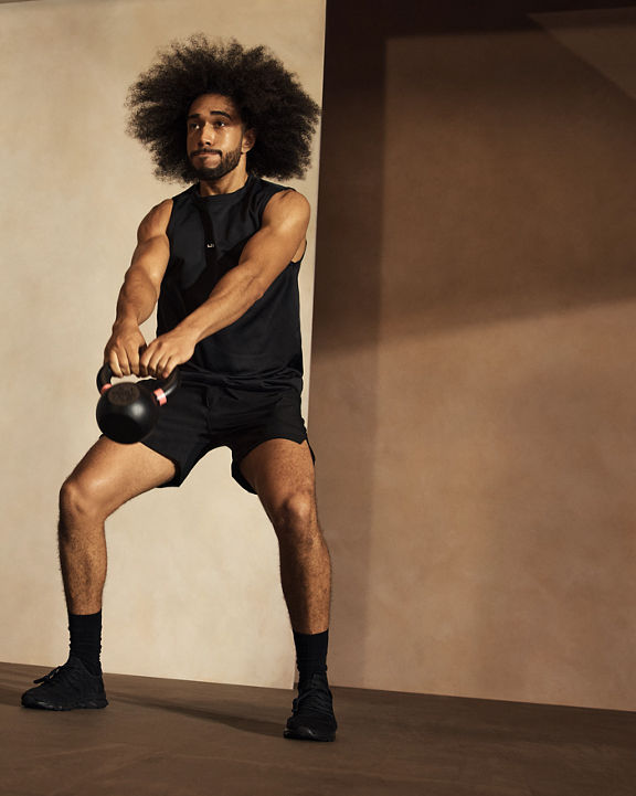 Alpha class participant working out with a kettlebell