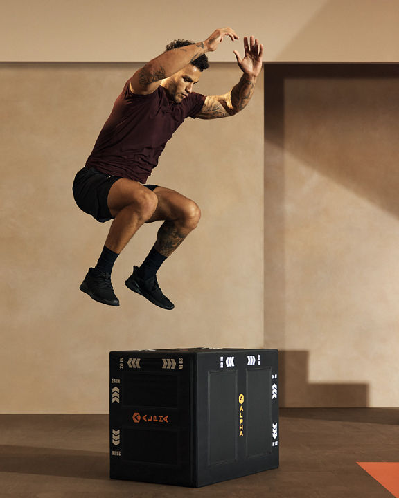 Alpha class participant jumping on to a plyo box