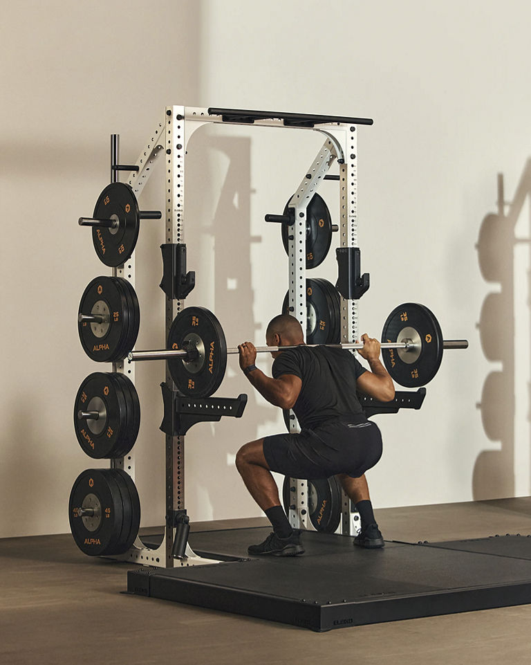 a man doing a barbell back squat
