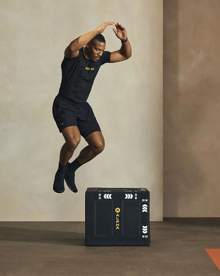 a man jumping over a box