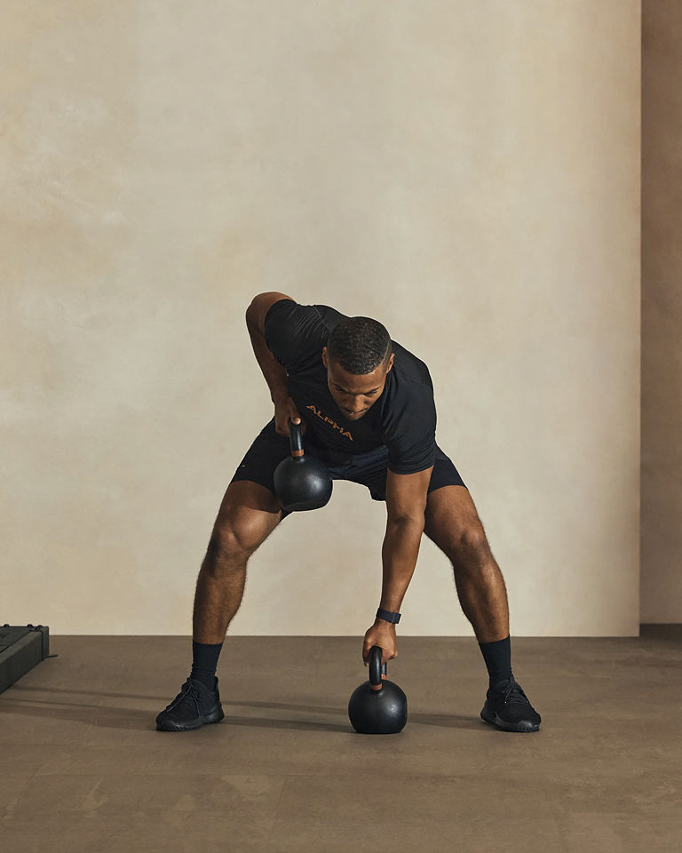 a man doing a bent over kettlebell row