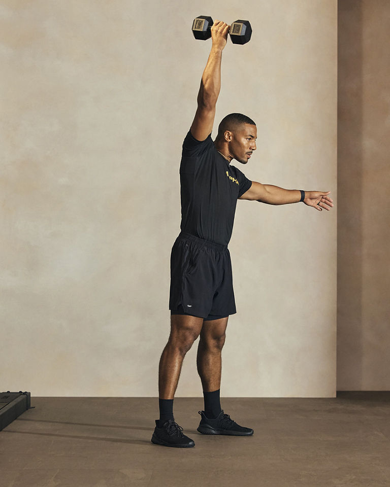 a man doing a single arm dumbell snatch