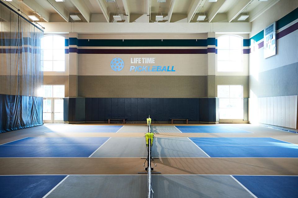 3 indoor pickleball courts in a brightly lit gymnasium