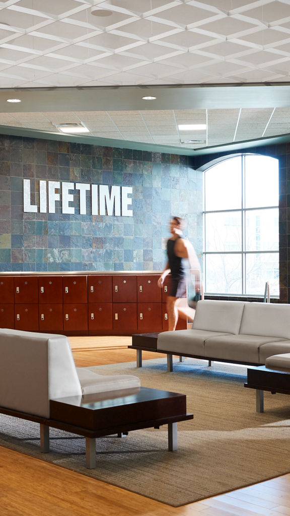 Couch seating area on the fitness floor at Life Time