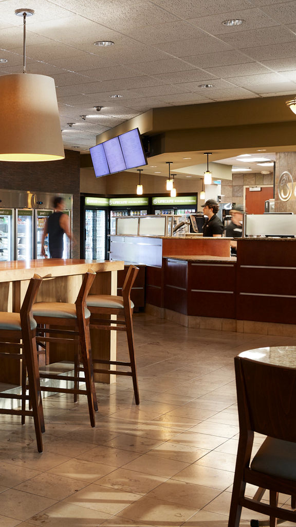 Chairs, tables, and a counter for ordering at a Life Cafe