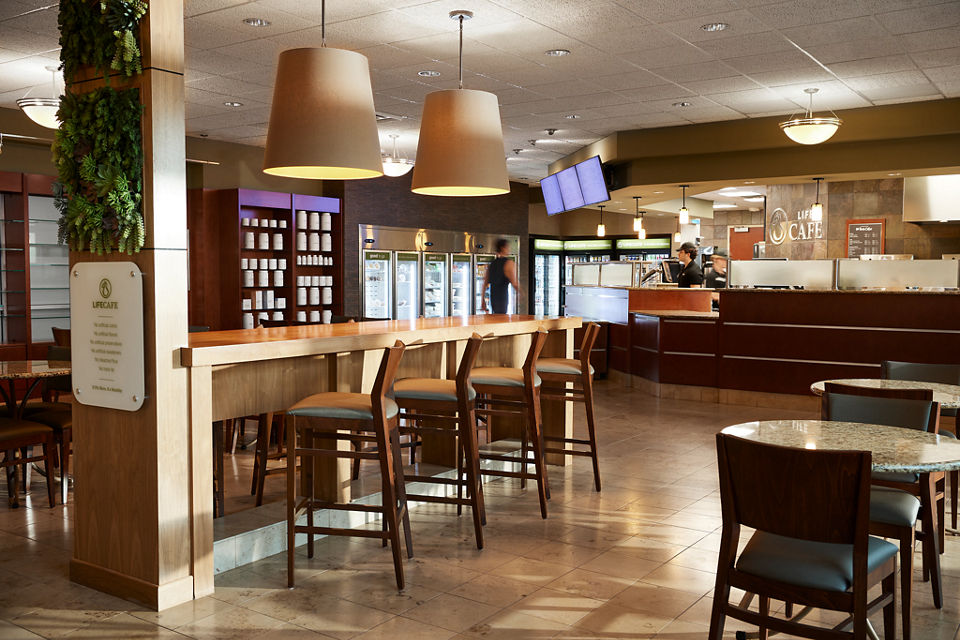 Chairs, tables, and a counter for ordering at a Life Cafe