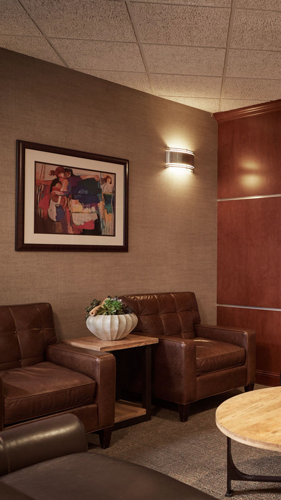 Seating area with television in a locker room at Life Time