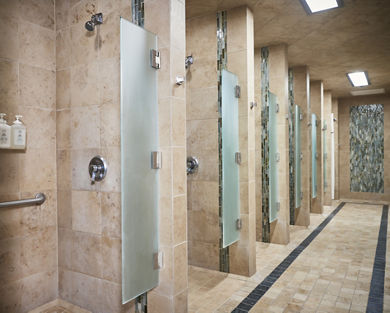 Row of shower stalls in a locker room at Life Time
