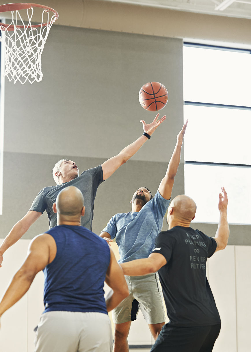 group of male playing a pickup game and jumping in the air