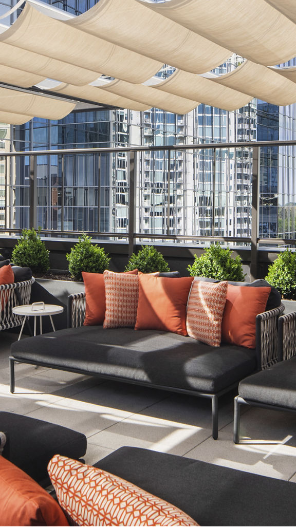 Outdoor loungers with shading overhead on a rooftop patio