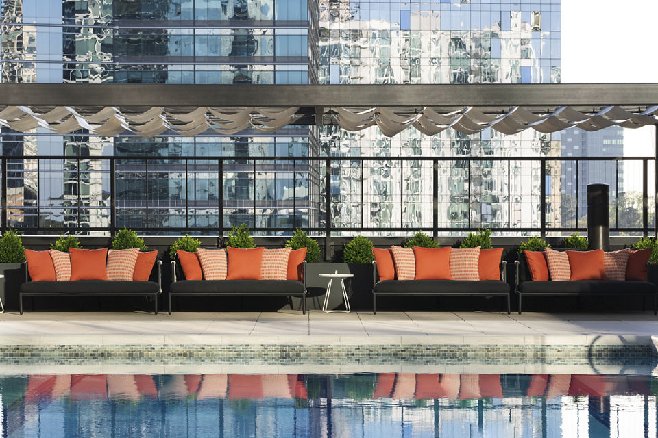 Outdoor couches by a rooftop pool