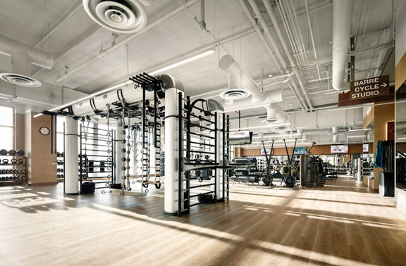 An outrace machine and other workout equipment on a Life Time fitness workout floor