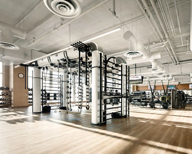 An outrace machine and other workout equipment on a Life Time fitness workout floor