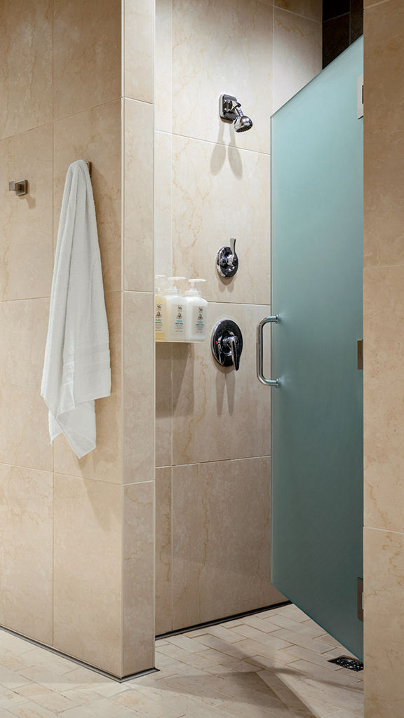 Shower stalls inside a locker room at Life Time