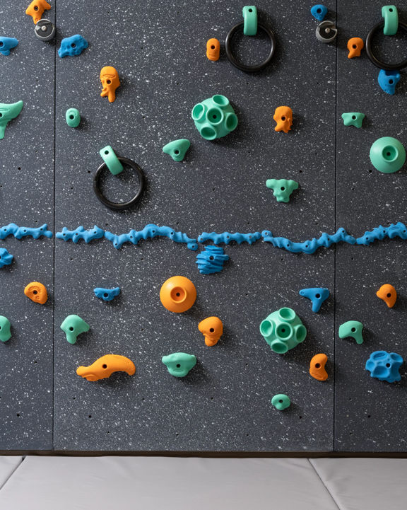 Climbing wall with colorful pegs