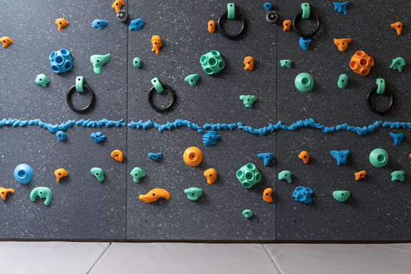 Climbing wall with colorful pegs