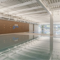 Brightly lit indoor leisure and lap pool at Life Time