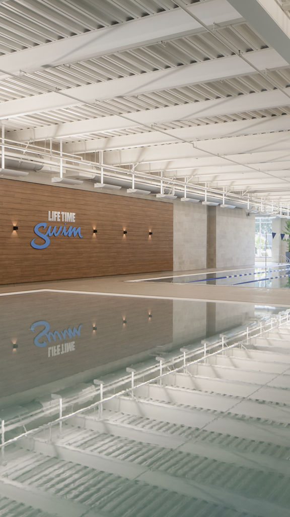 Brightly lit indoor leisure and lap pool at Life Time