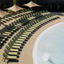 Pool lounge chairs lined up next to a zero-depth entry pool