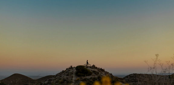 biker on top of a hill admiring the view
