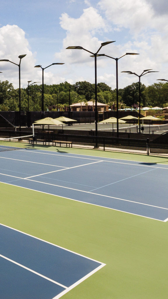 Multiple outdoor tennis courts at a Tennis facility