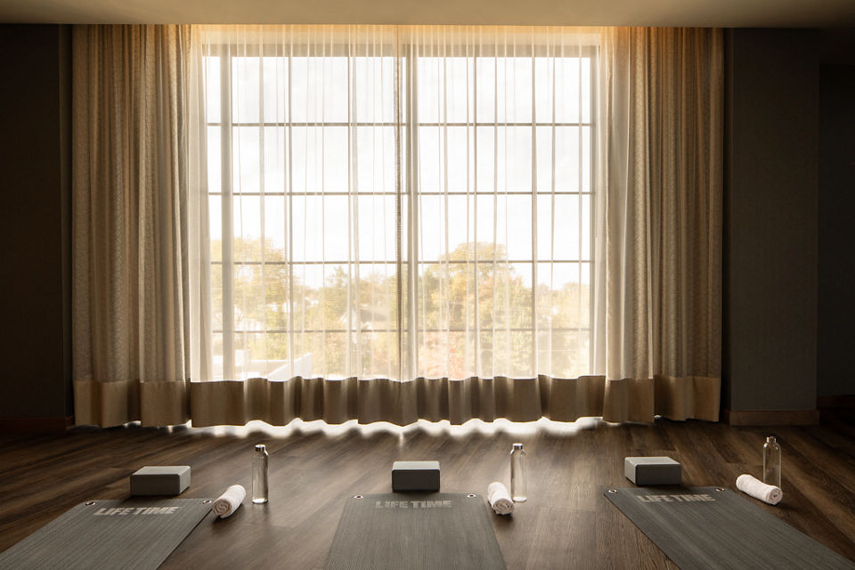 Sunlight shining through sheer curtains in a yoga studio at Life Time