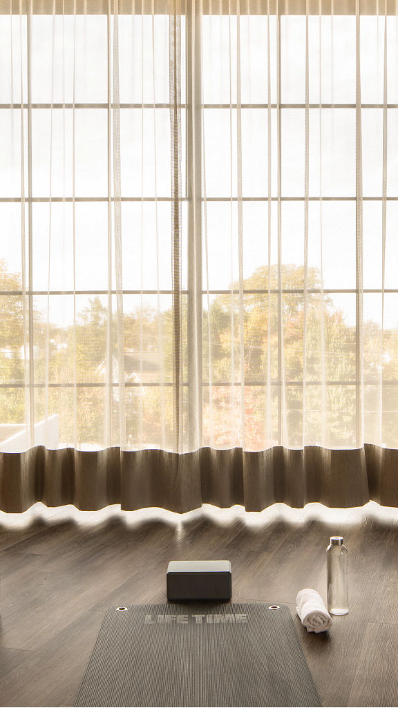 Sunlight shining through sheer curtains in a yoga studio at Life Time