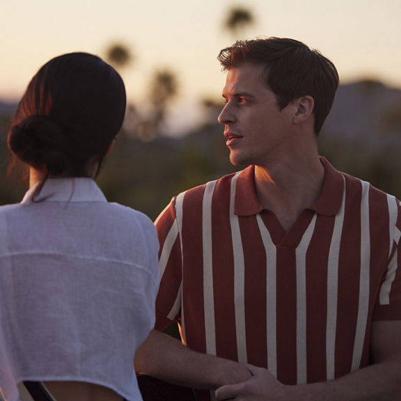 A couple standing together with mountains in the far distance