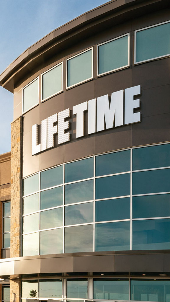 The exterior and front enterance of a Life Time location