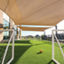 Two soccer goals stand next to each other with a soccer ball in between on an outdoor turf field