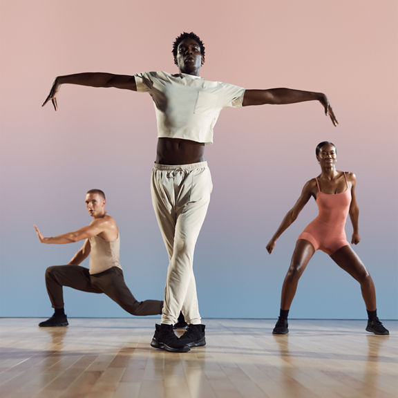 Three danze class participants in various positions at Life Time