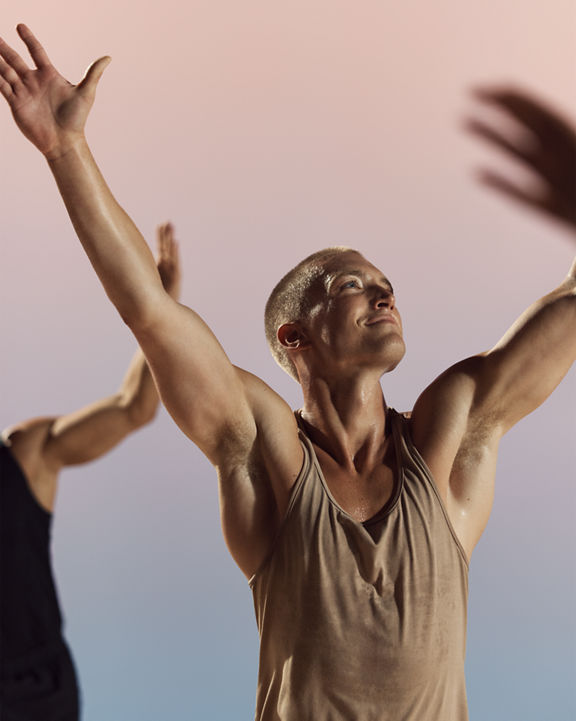 Danze class participants with arms raised at Life Time