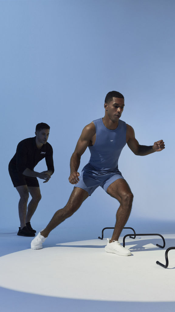 A client running through small hurdles during a training session