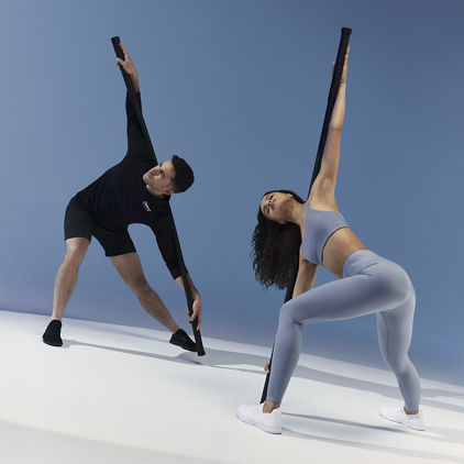 A client and trainer using weighted bars during a Dynamic Personal Training session