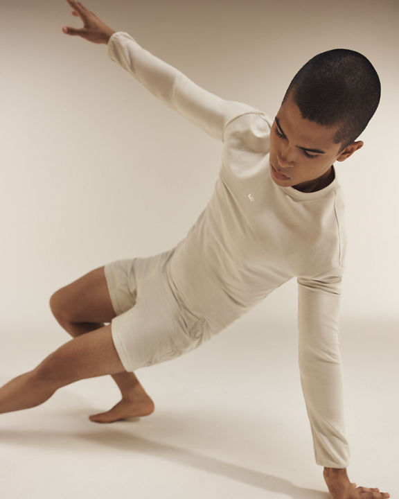 Portrait of an adult male in a side-plank position balancing on one arm