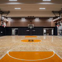 An indoor basketball court and gymnasium in New York with Uhoops branding
