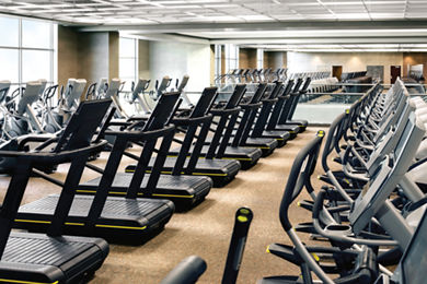 Rows of uniformly placed treadmills on the fitness floor at Life Time