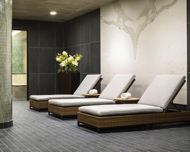 Lounge chairs next to an indoor whirlpool