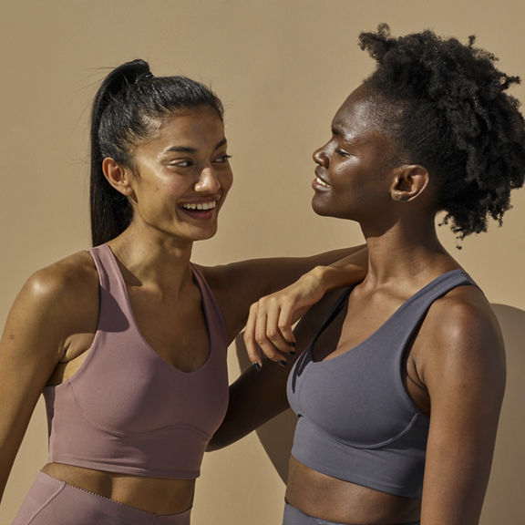 Female diverse couple of friends having a laugh portrait