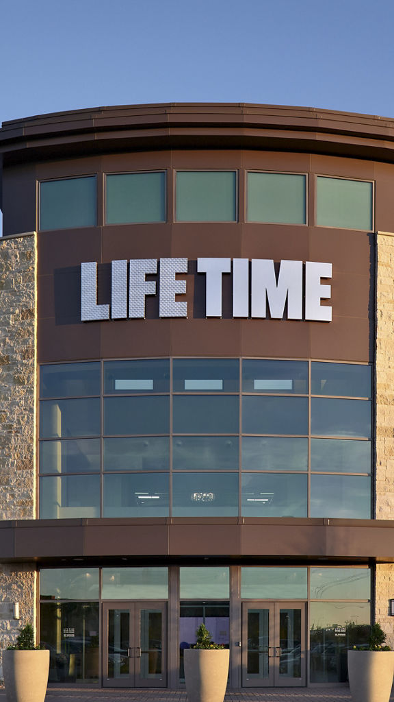 The exterior and front enterance of a Life Time location